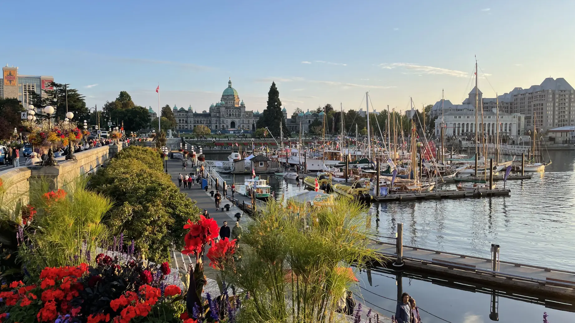 view overlooking the inner harbour of Victoria BC, people walking alongside the docked boats