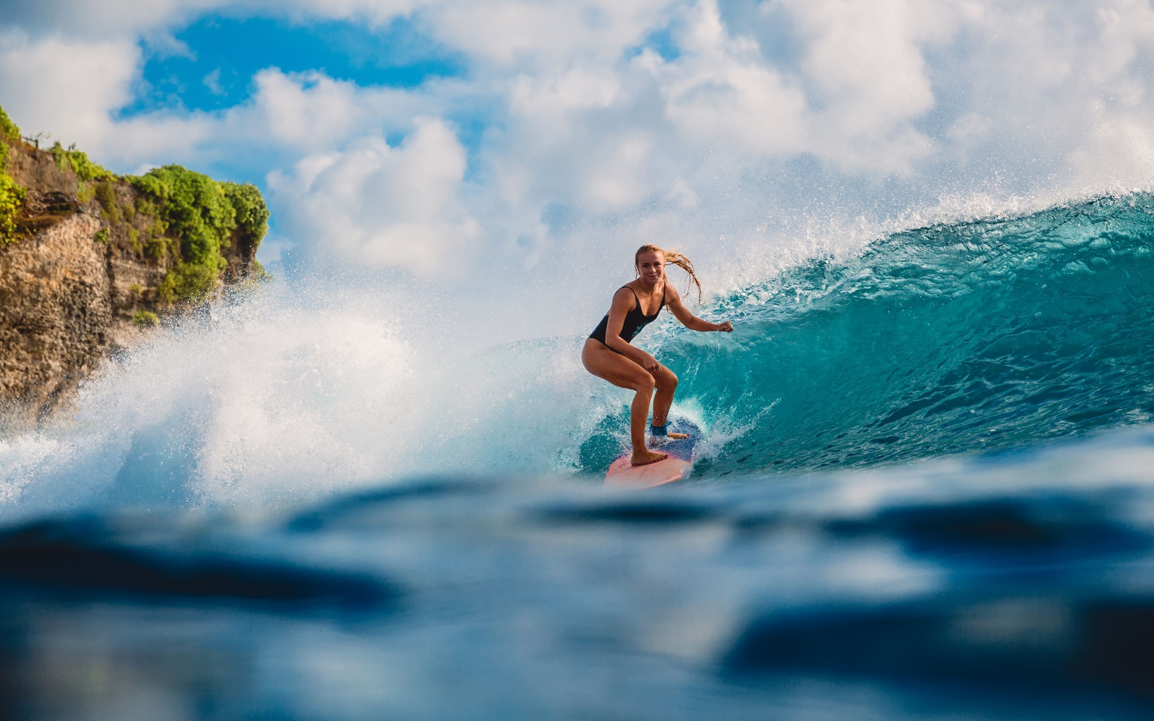 Een vrouw surft in Tahiti
