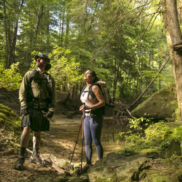 A pair of hikers stopped on the trail to admire the view of Bankhead National Forest in Alabama, USA