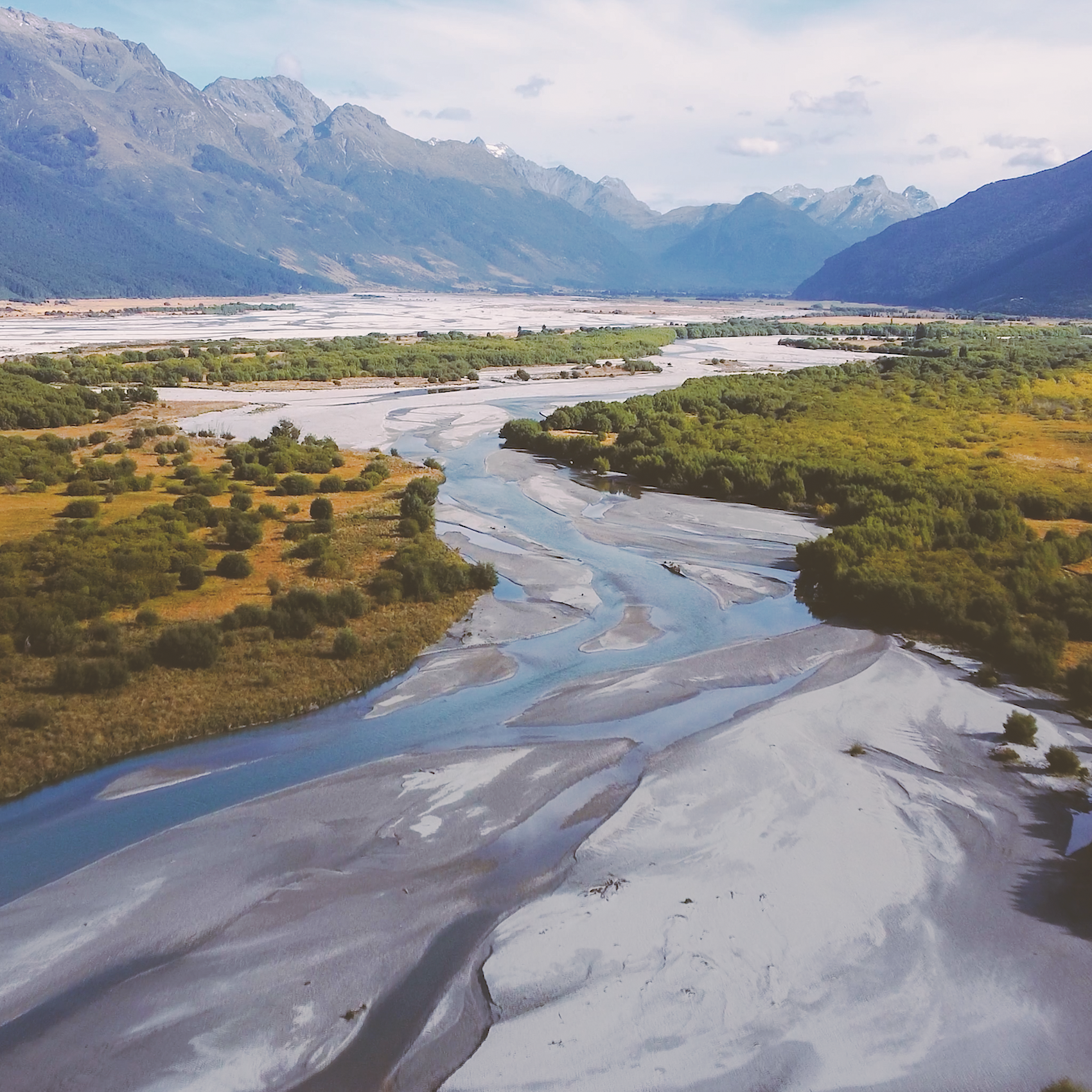 An aerial view on a river and mountains in New Zealand