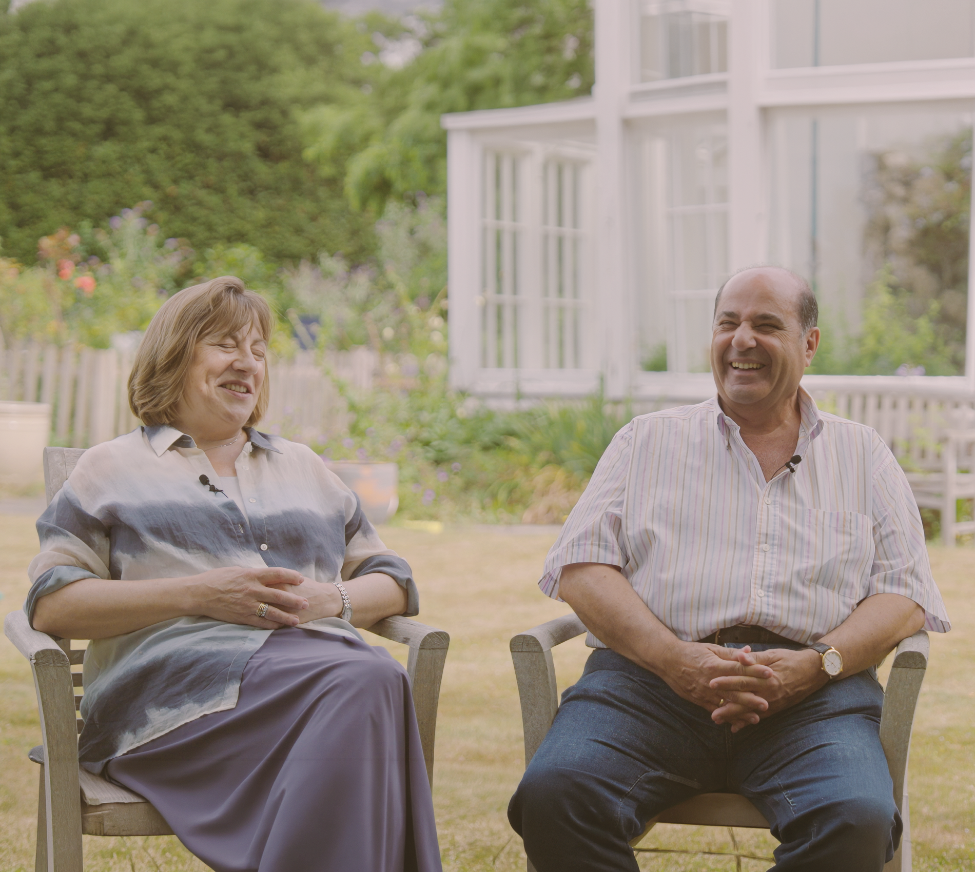 A couple sit in a garden and recall stories of their holiday Down Under