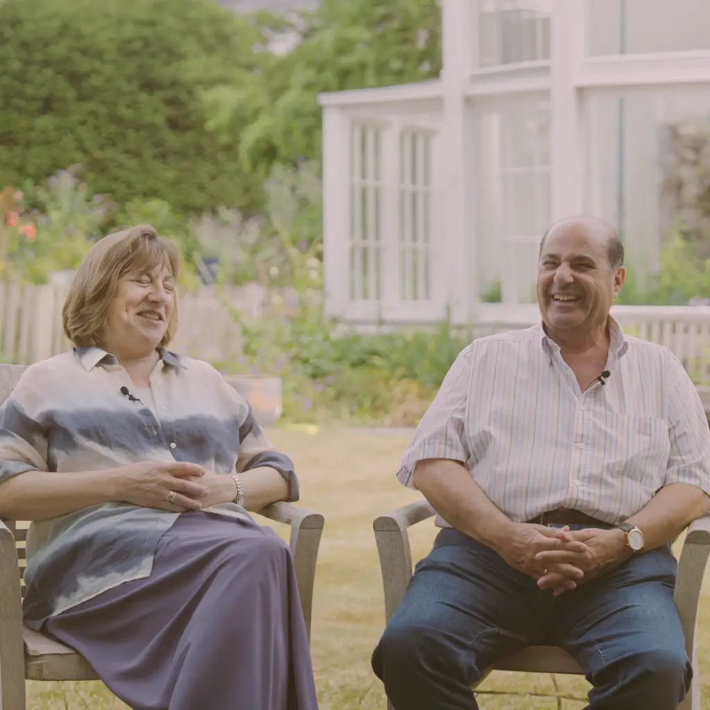 A couple sit in a garden and recall stories of their holiday Down Under