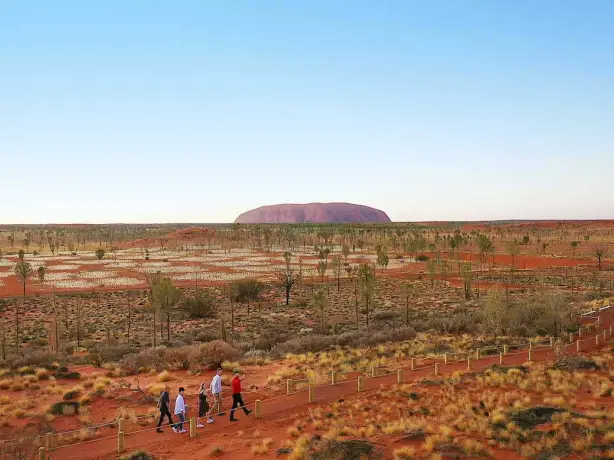 People walking along a path through the Uluru National Park in Australia