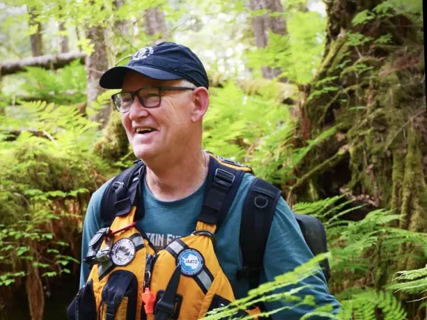 A local guide in the forest wearing a life jacket in British Columbia