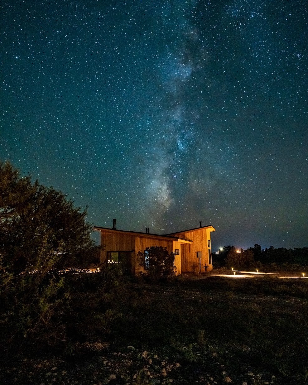 Wooden house accommodation at night, surrounded by stars in the Grand Cayon