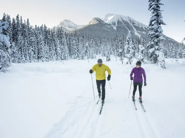 ca_couples_winter cross country skiing great divide trail lake louise