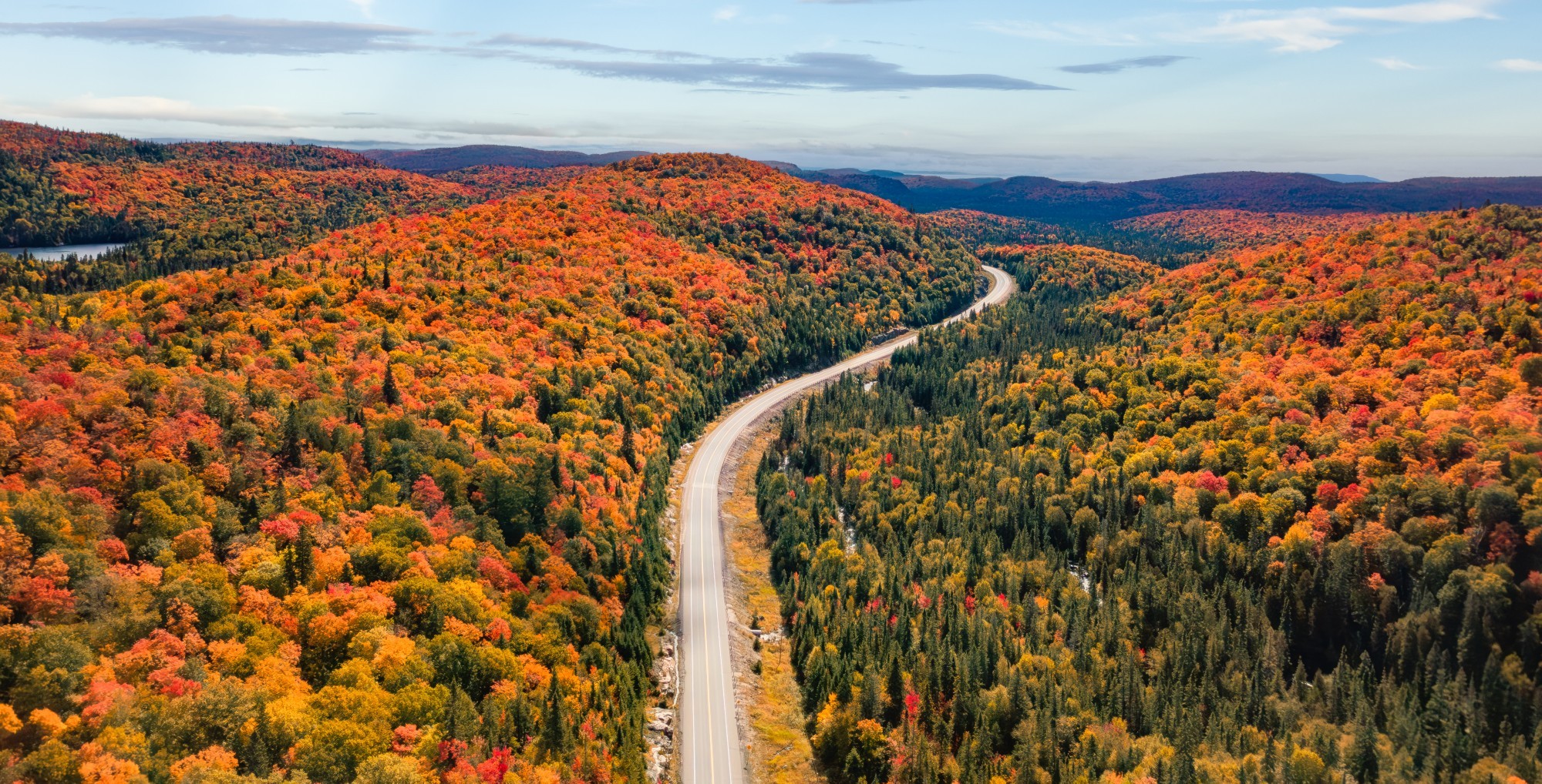 Straße schlängelt sich durch hügelige und bunte Herbstlandschaft in Ontario