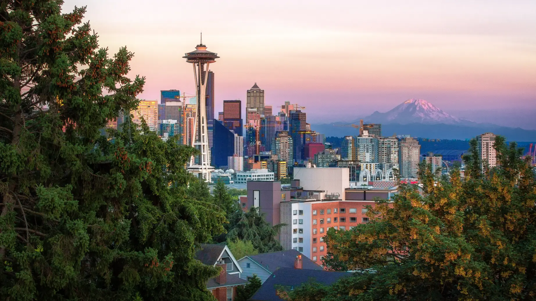 Seattle city skyline at sunset with mountain in background