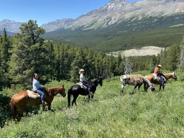 People horse riding in the mountains