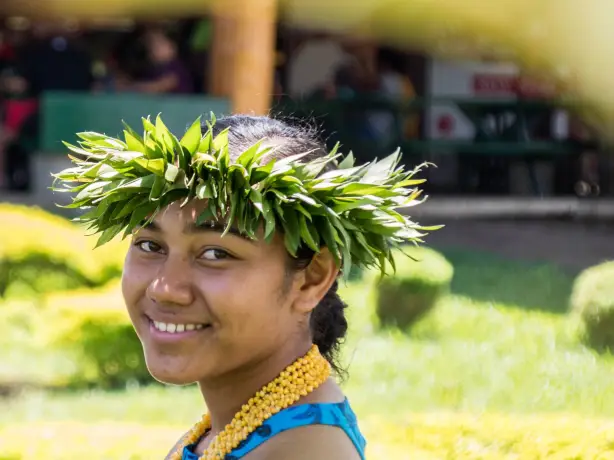 A woman smiling at the camera in a traditional outfit