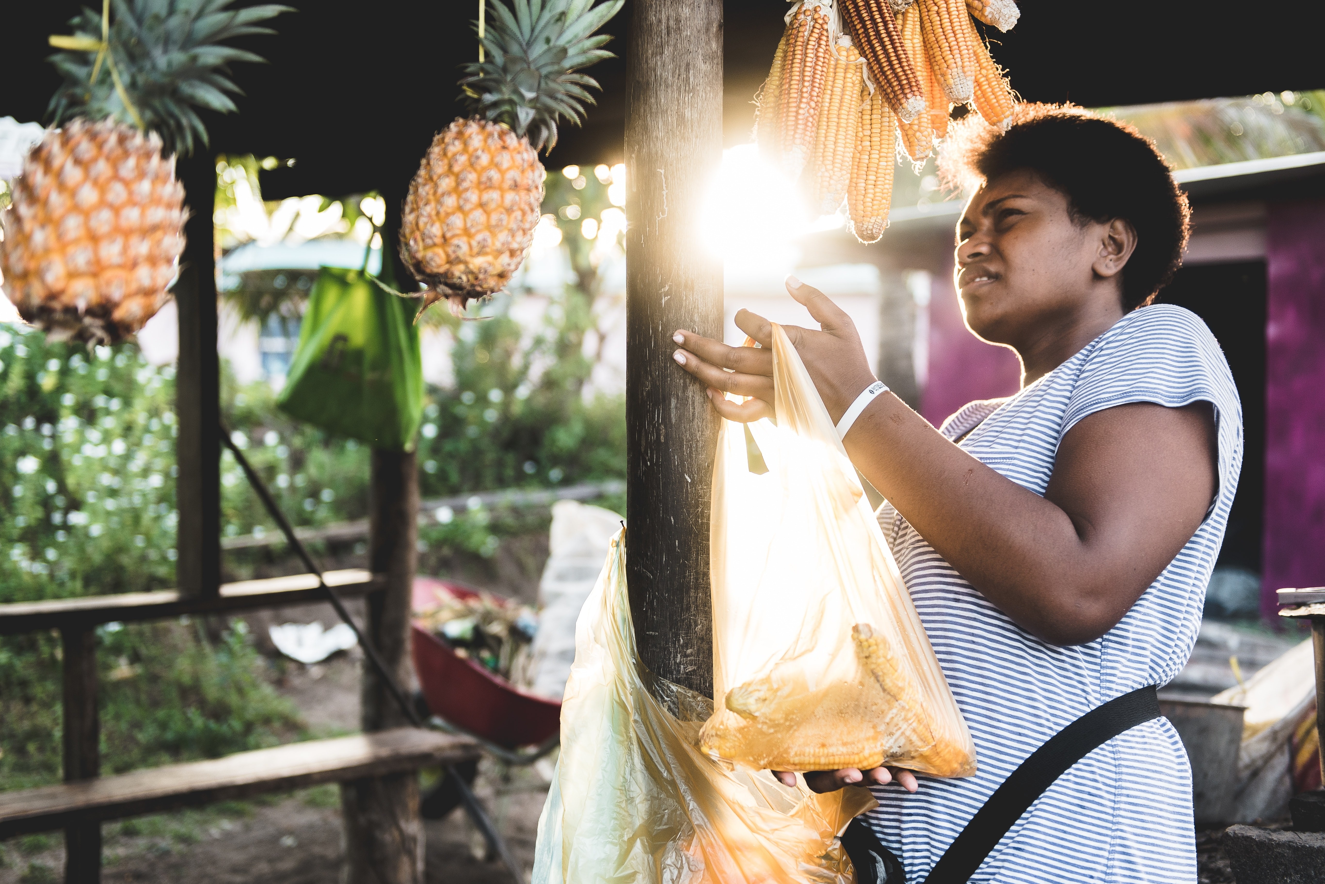 Een vrouw met ananas en maïs