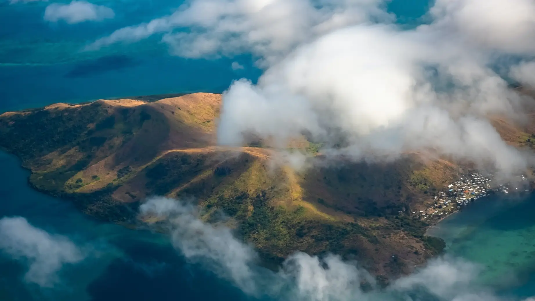 Luftaufnahme einer Insel durch die Wolken