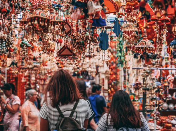 Image of people walking away from the camera and into the Singapore markets