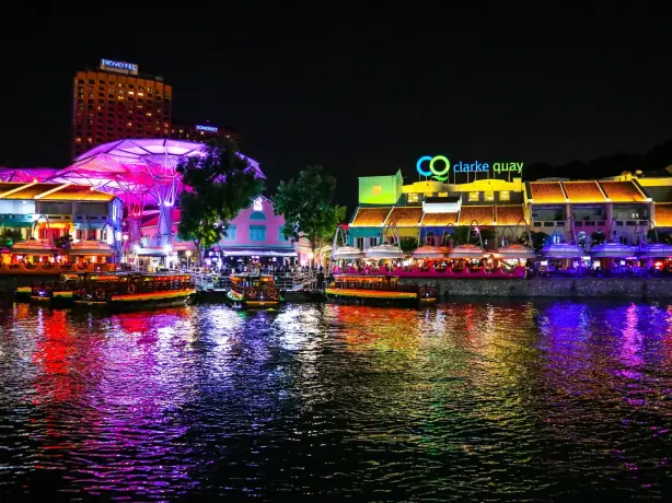 River at night with brightly lit promenade