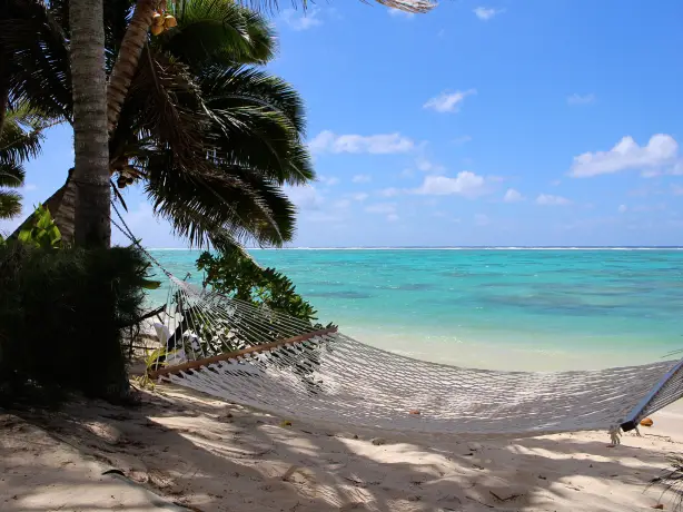 A hammock on the beach with the ocean in the background, Cook Islands