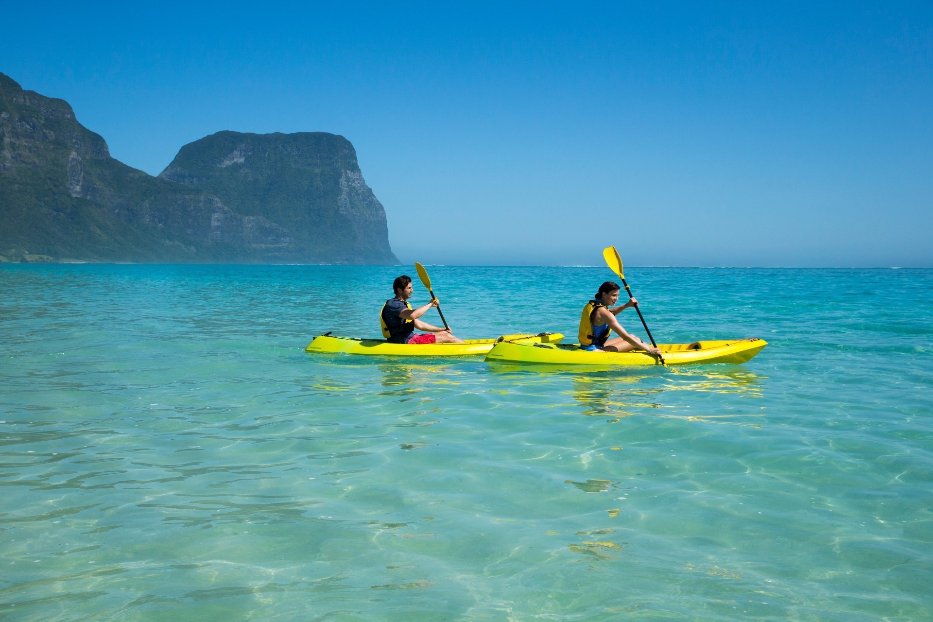 Two people sea kayaking on Lord Howe Island, Australia