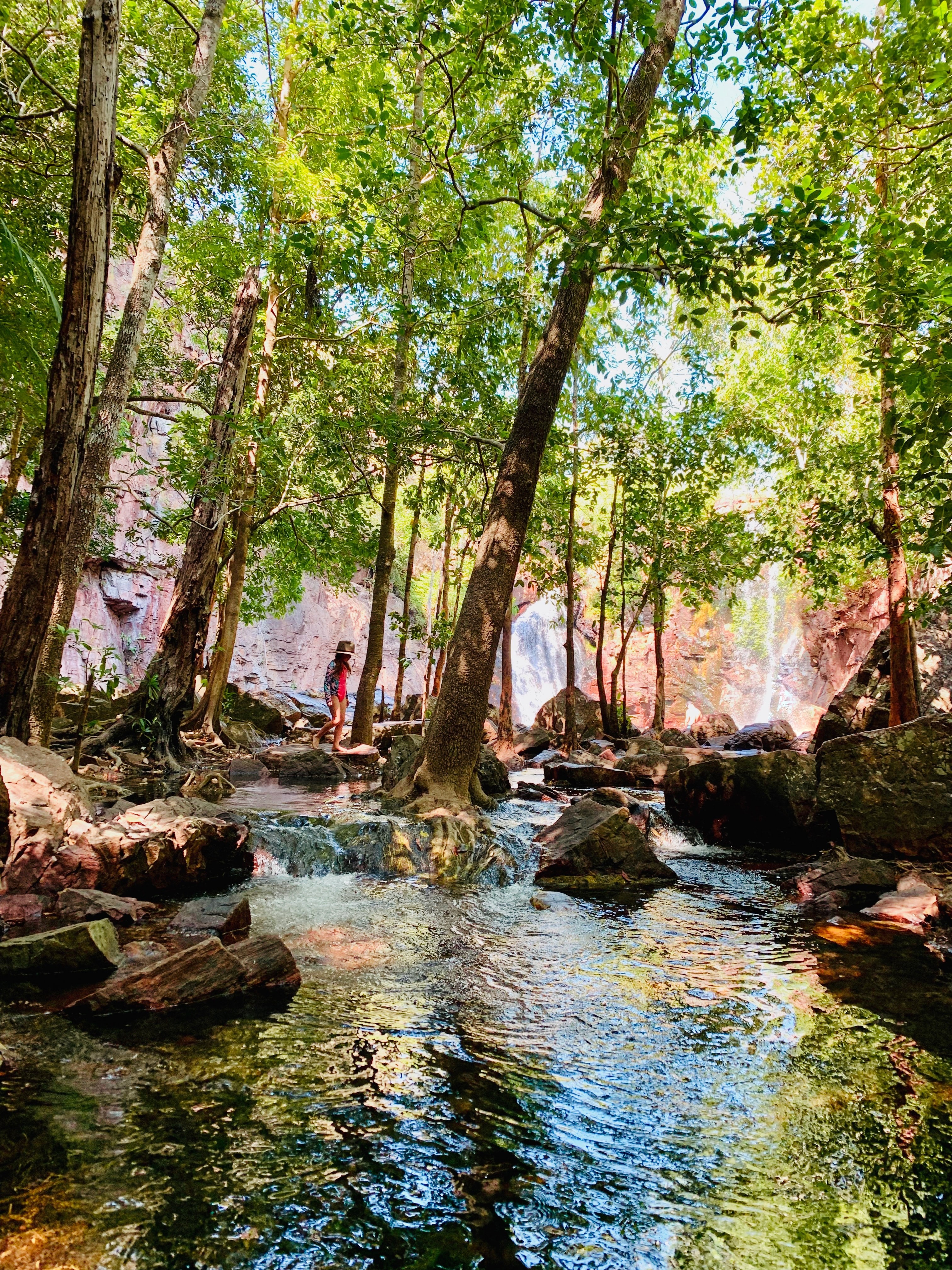 A child is playing at a little stream at Litchfield Wangi Falls
