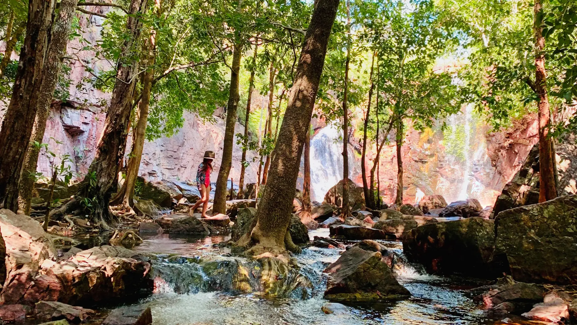 A child is playing at a little stream at Litchfield Wangi Falls