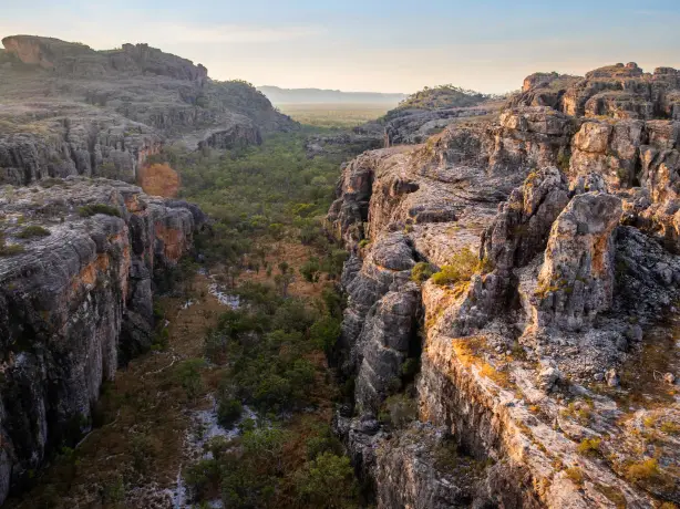 Eine grüne Schlucht, eingebettet zwischen felsigen Klippen im Kakadu National Park, Australien