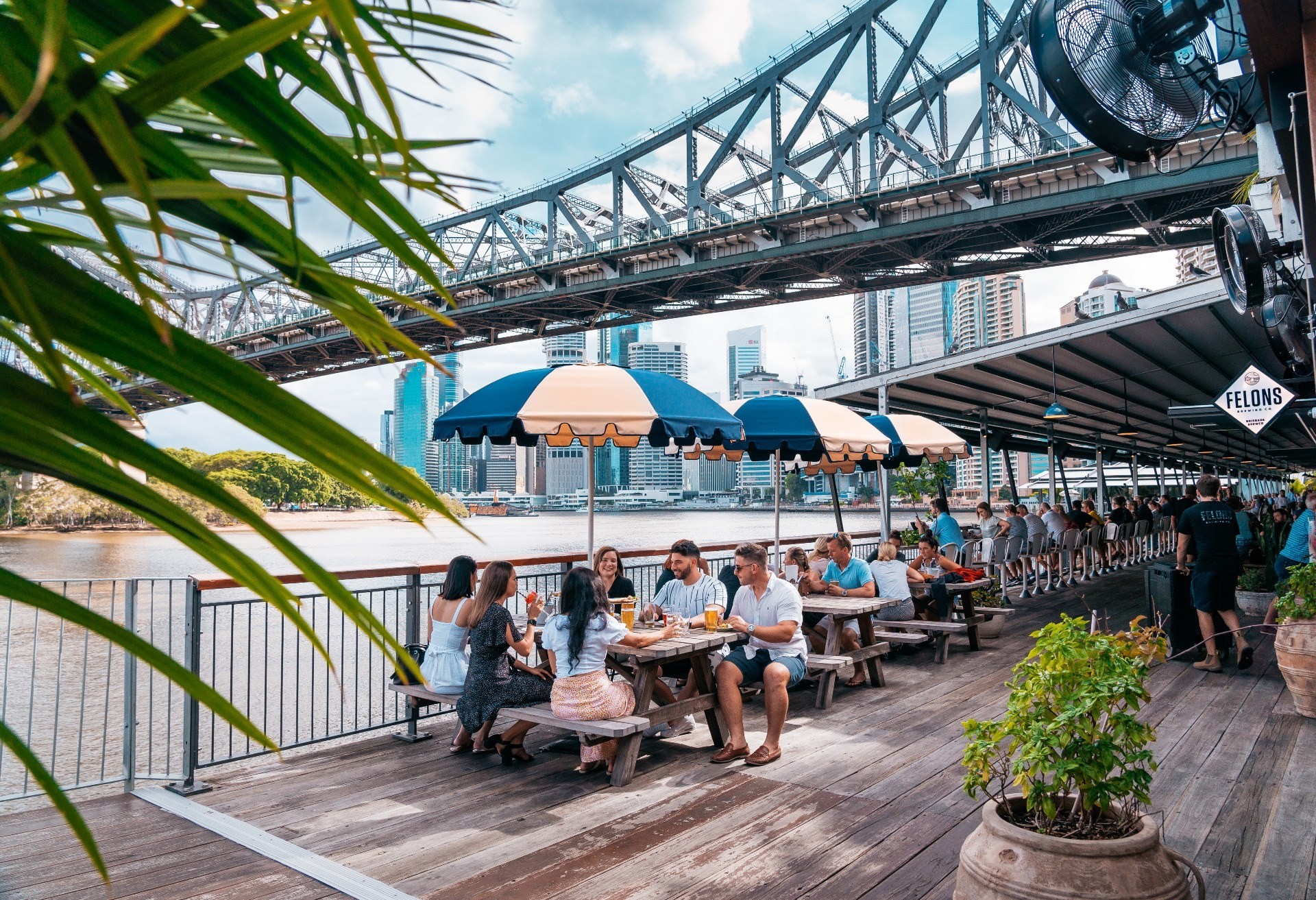 Australia, Queensland – outdoor dining by the river in Brisbane beneath the Story Bridge. (Credit: Tourism and Events Queensland)