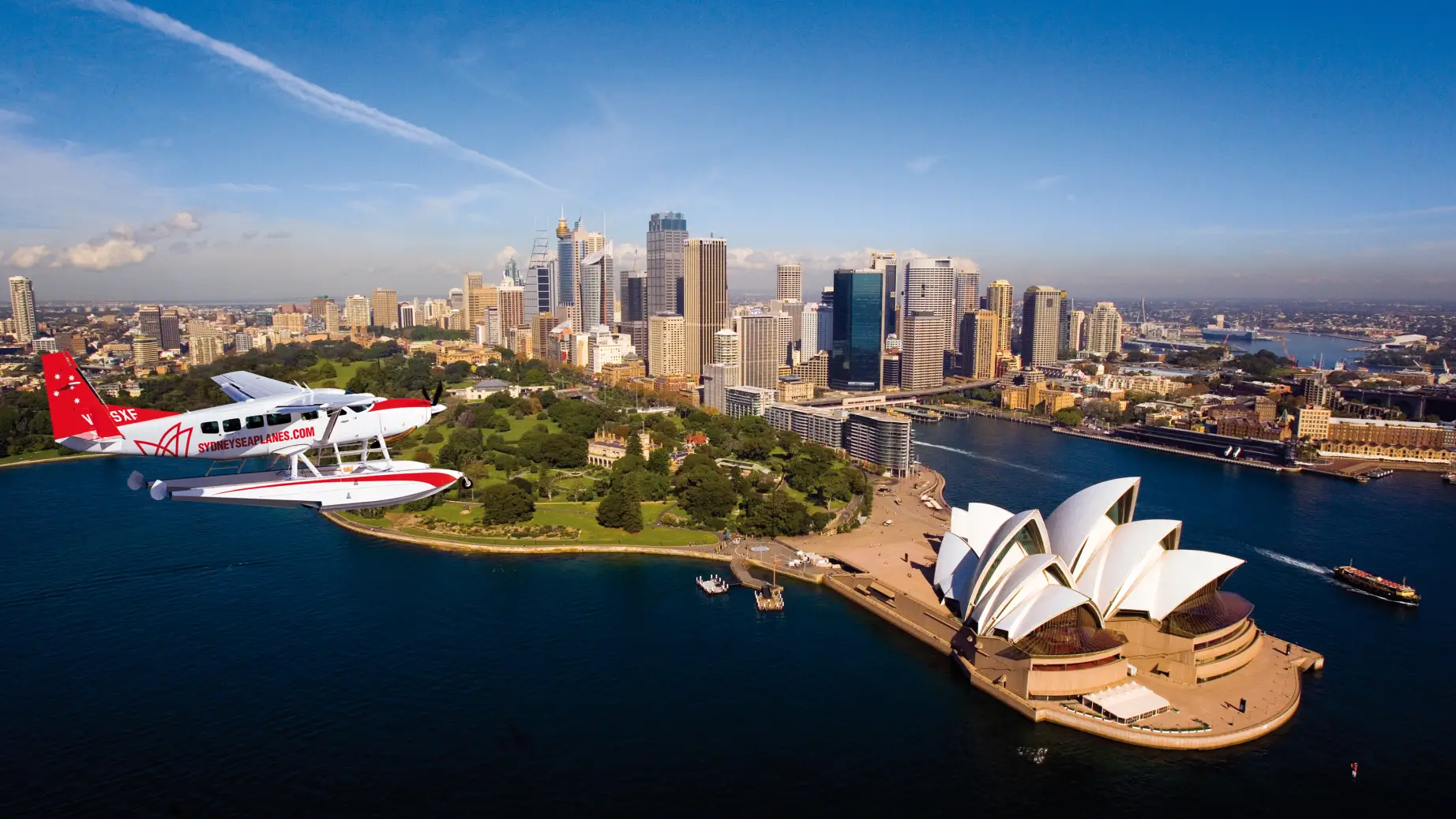 Sydney - ein Blick aus der Luft auf die Skyline und das Opernhaus mit einem Wasserflugzeug von Sydney Seaplanes