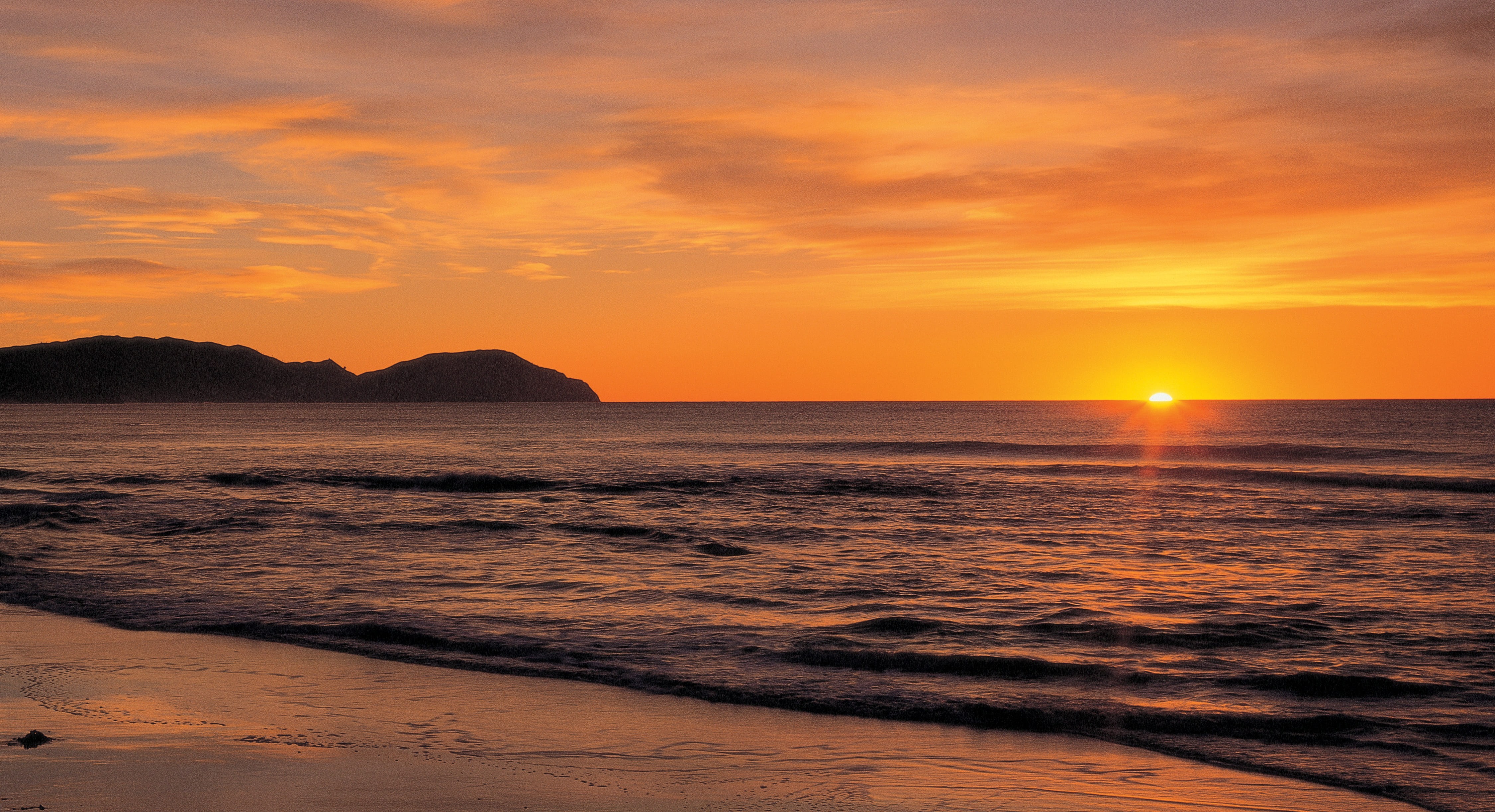 Sonnenaufgang über dem Meer am Wainui Beach in Gisborne Neuseeland