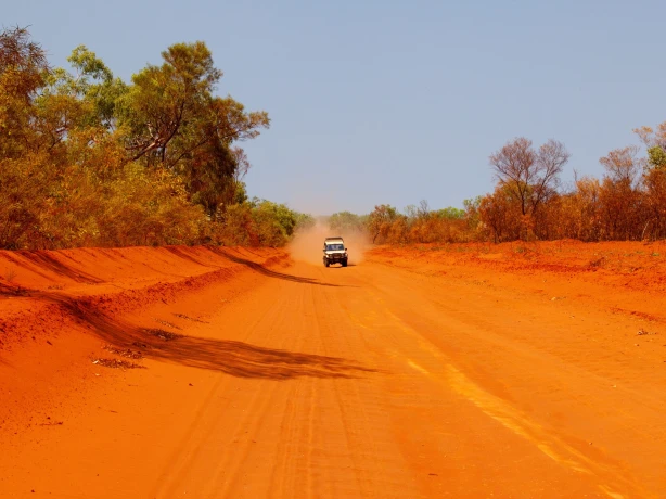 Australia, Alice Springs – a car driving along a dirt road