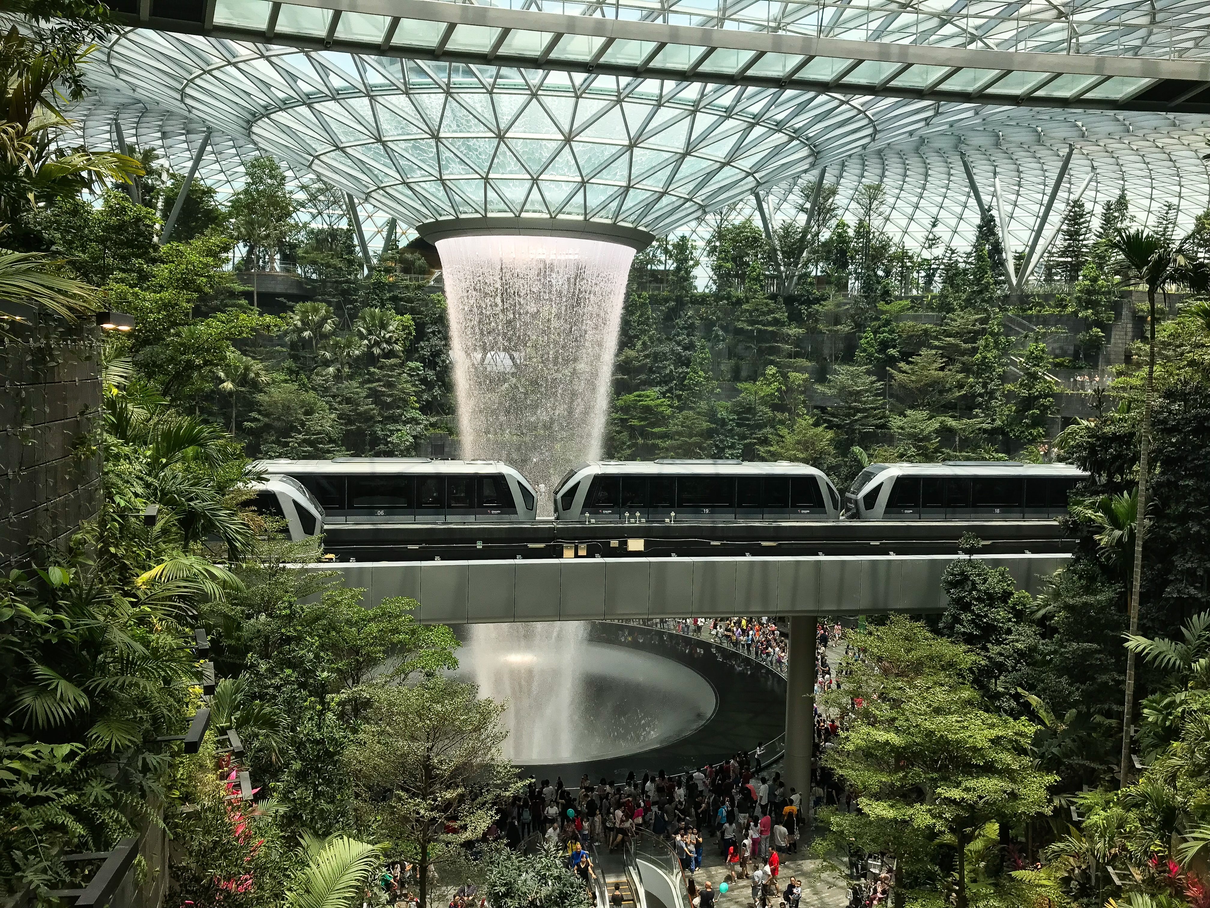 Large waterfall and train in Singapore airport