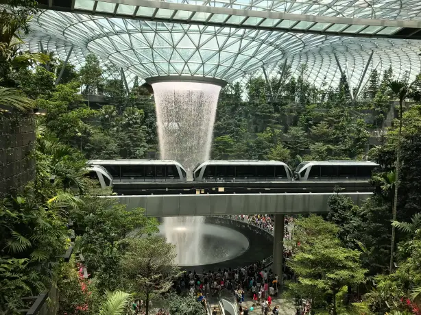 Large waterfall and train in Singapore airport