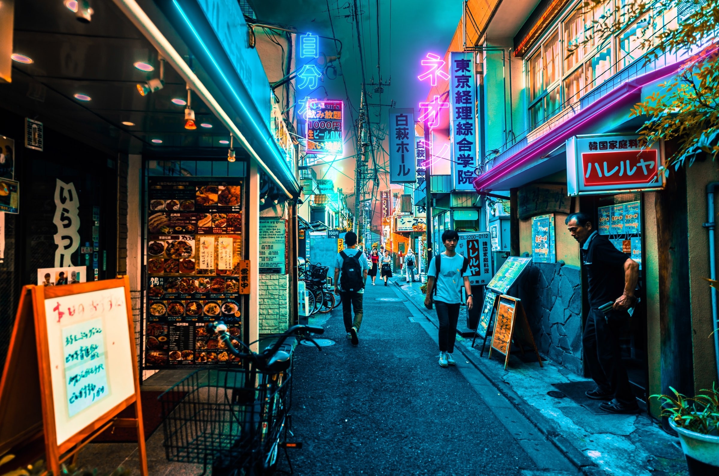 Busy street alley with neon lights at night in Tokyo