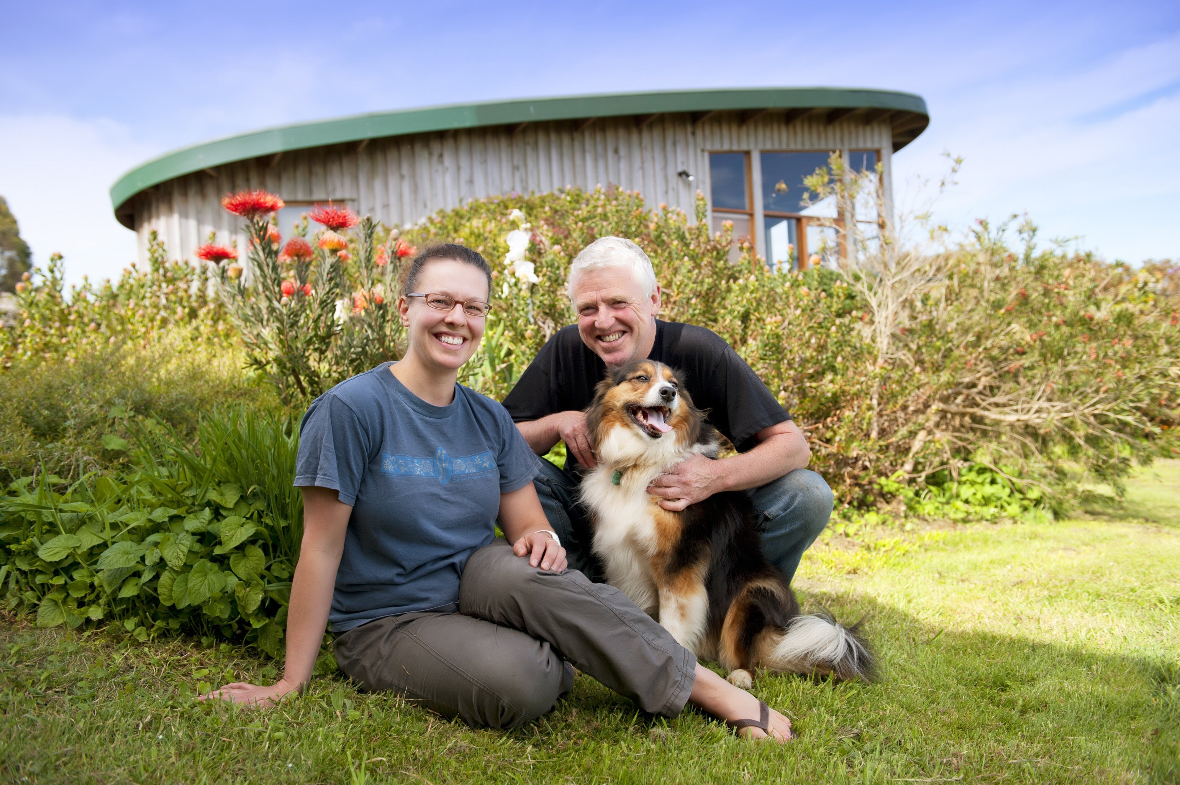Australia Great Ocean Road cottage hosts with dog smiling at the camera