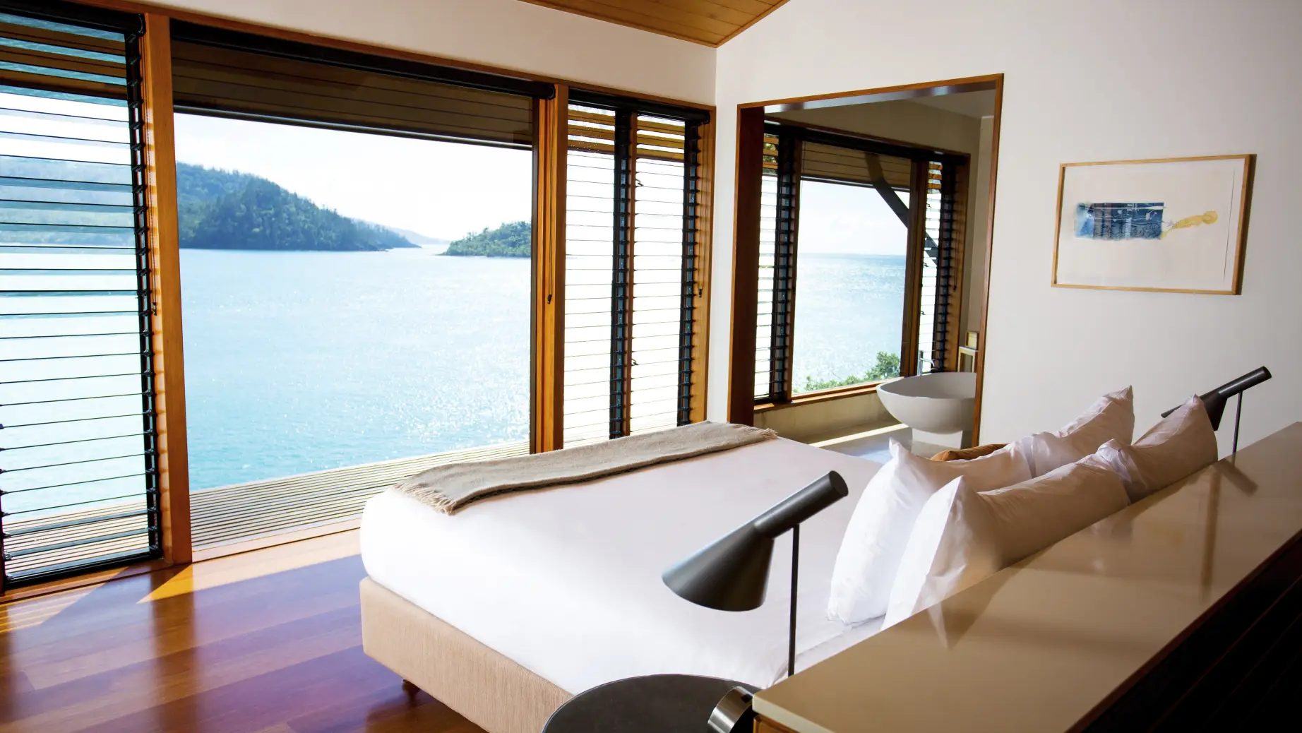 Hamilton island accommodation view looking over over the bed to the ocean view in the background