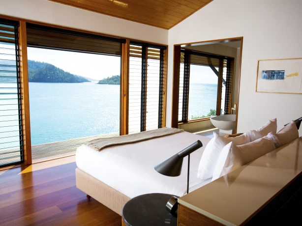 Hamilton island accommodation view looking over over the bed to the ocean view in the background