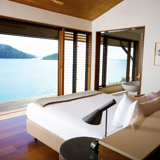 Hamilton island accommodation view looking over over the bed to the ocean view in the background