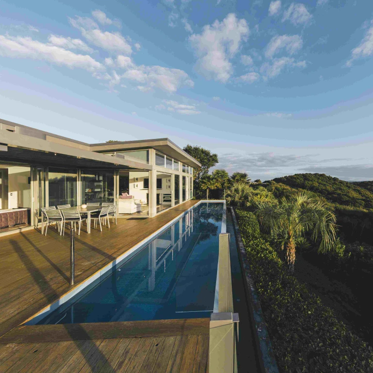 Accommodation with a pool and views over hills and water in New Zealand