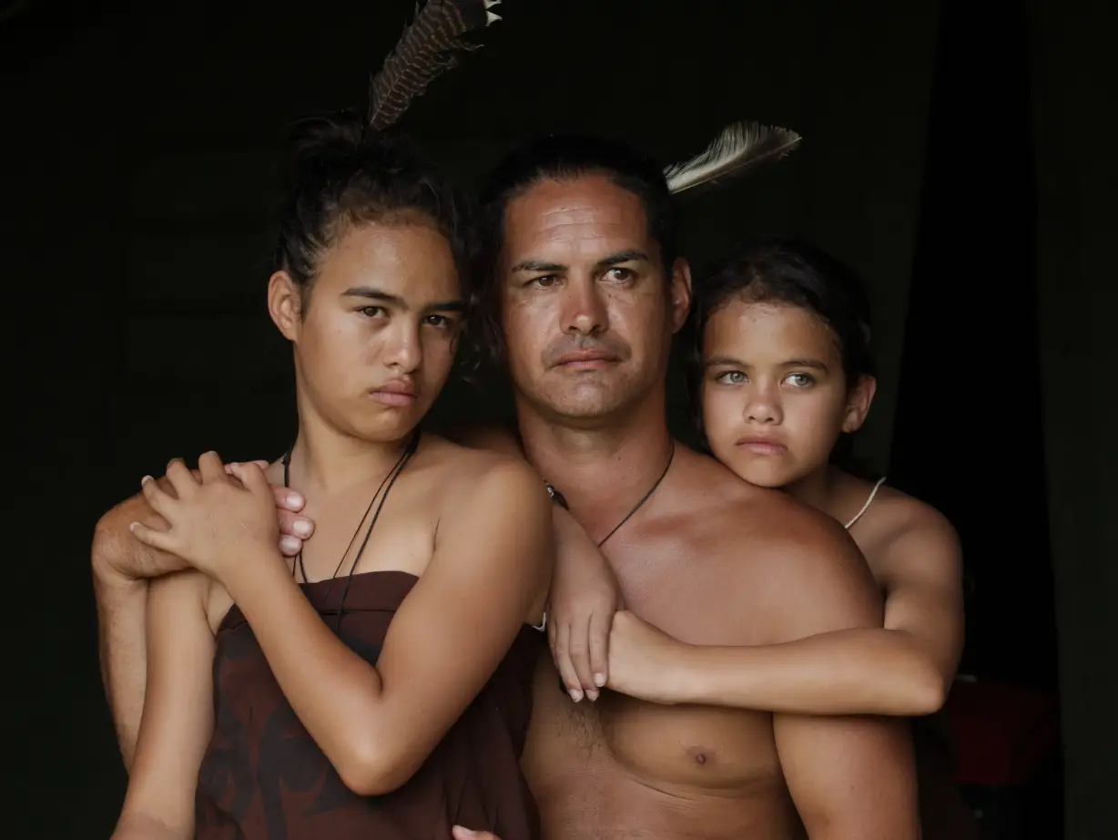 Portrait of a Māori family with a man and two young girls