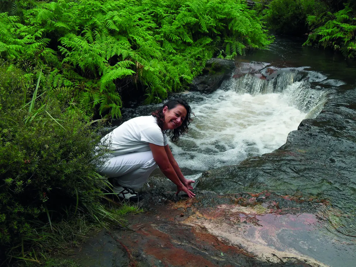 A woman in white clothing during a Rotorua Wikitoria Day Tour at the thermal river