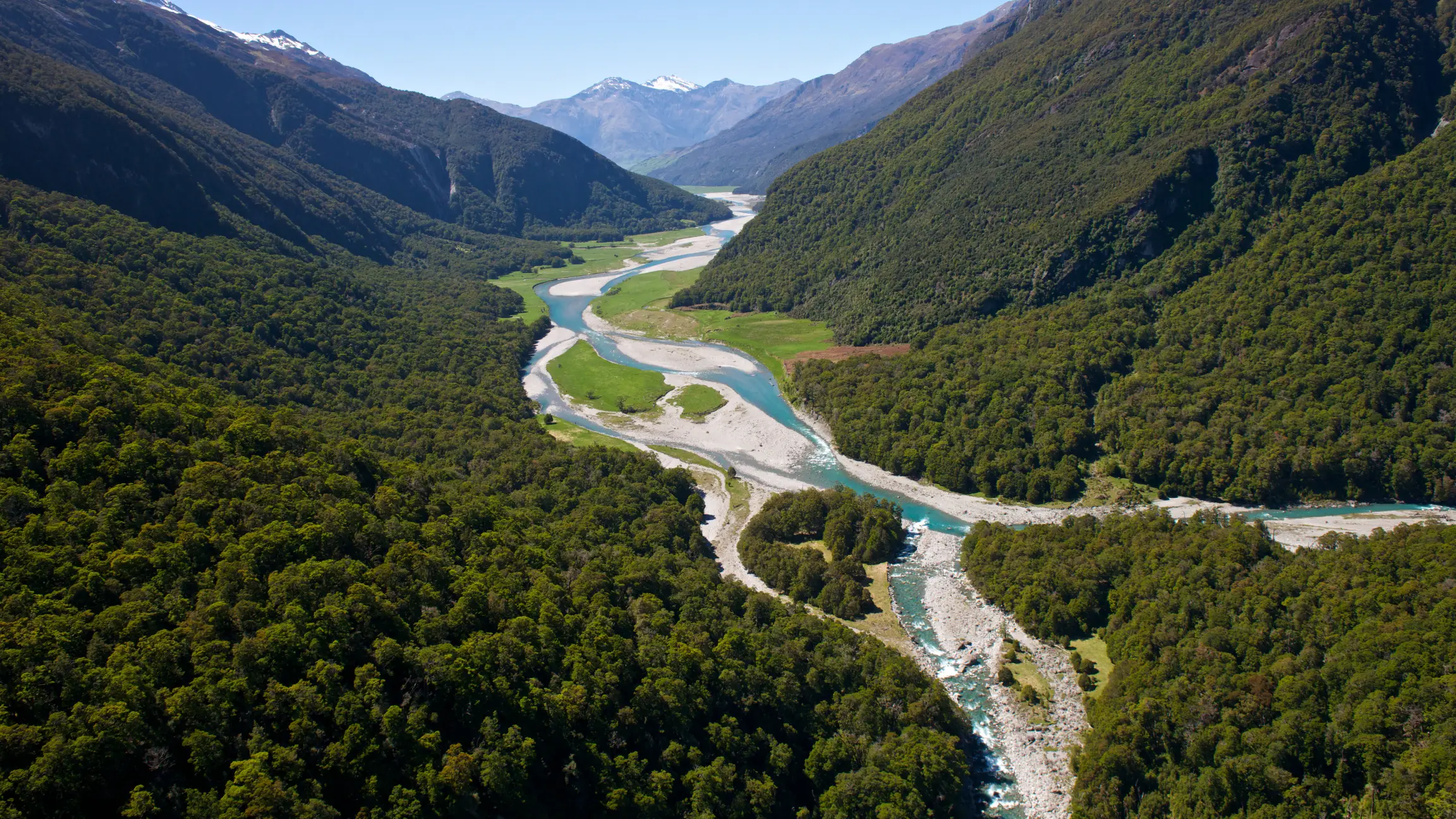 River running through mountain valleys - Makarora Wilkins Jets River Valley in New Zealand