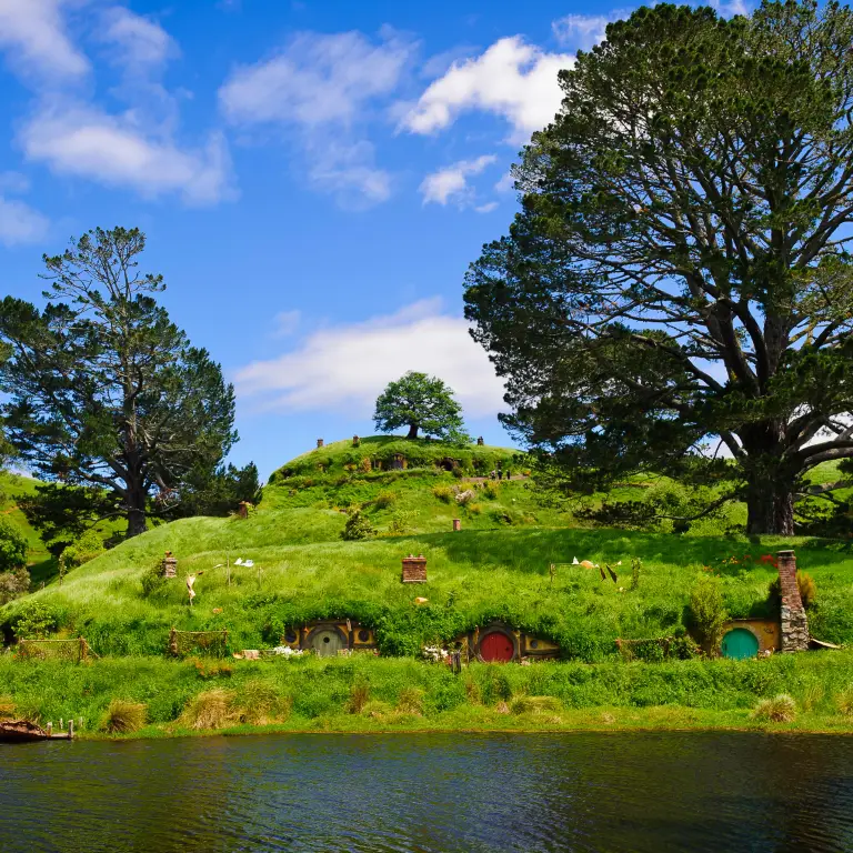 Hobbit holes on a hillside in Hobbiton in Waikato, New Zealand