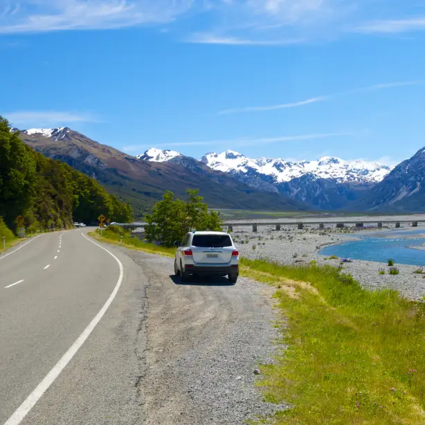 A car stopped on the side of the road of Arthur's Pass in New Zealand