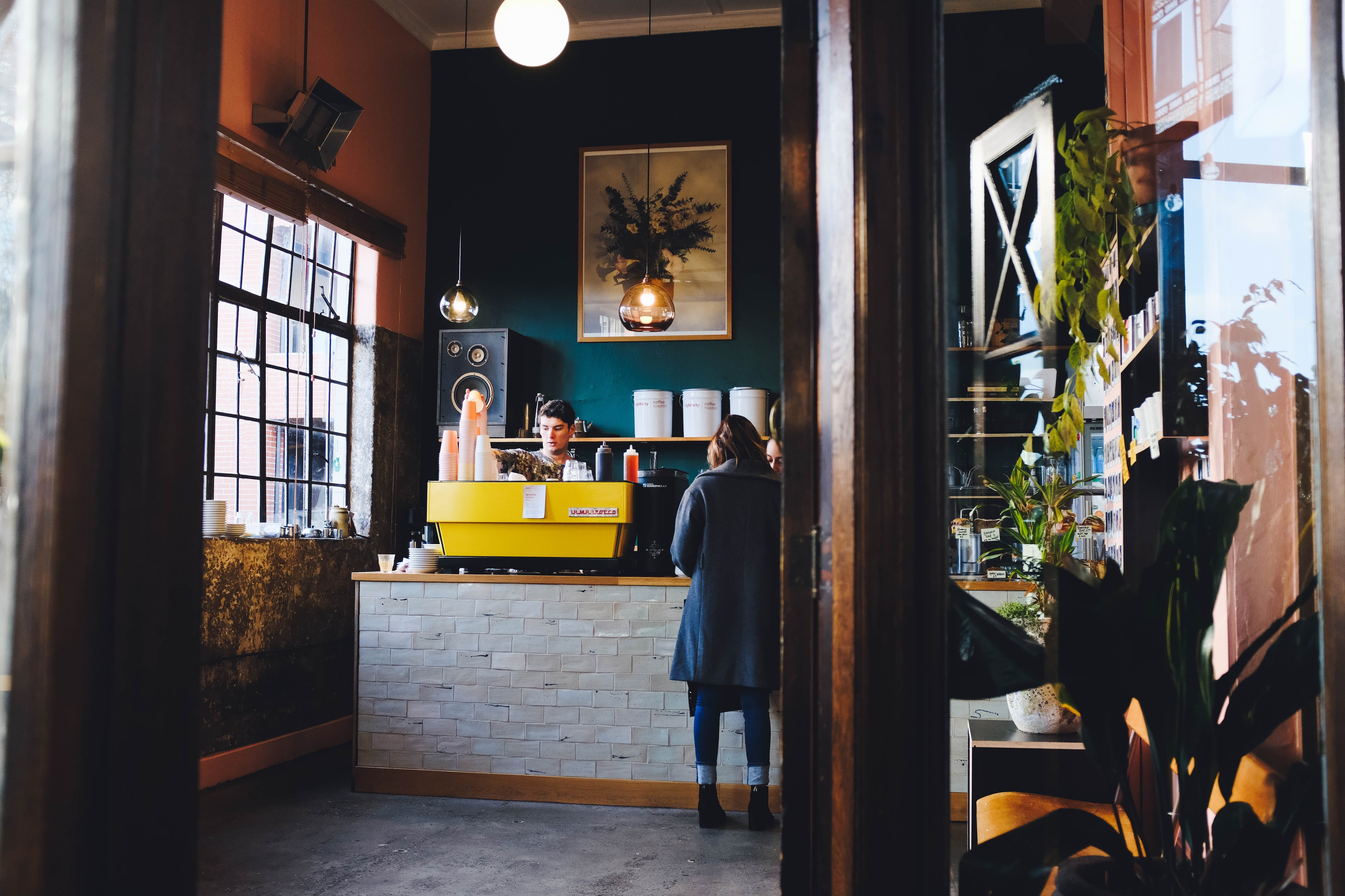 Personen stehen an Schalter in cafe in Neuseeland