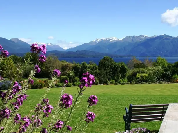 Nz te anau lodge garden view flowers mountain stays comfortable