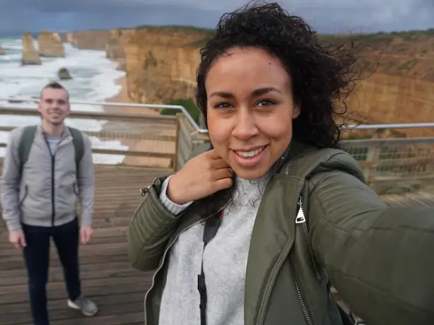 A couple take a selfie at a viewpoint of the Twelve Apostles on the Great Ocean Road, Victoria, Australia